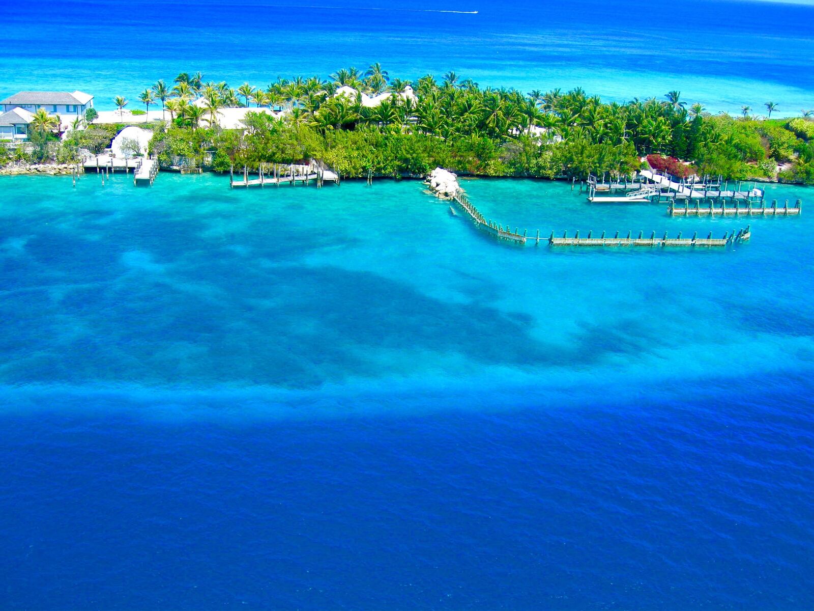 Aerial view of a turquoise Bahamas island resort with private piers