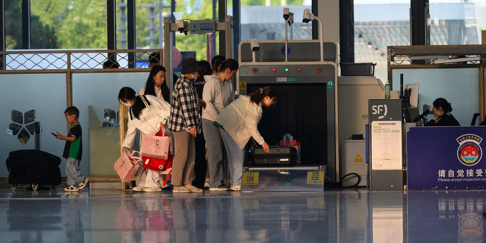 Security screening luggage at a terminal checkpoint