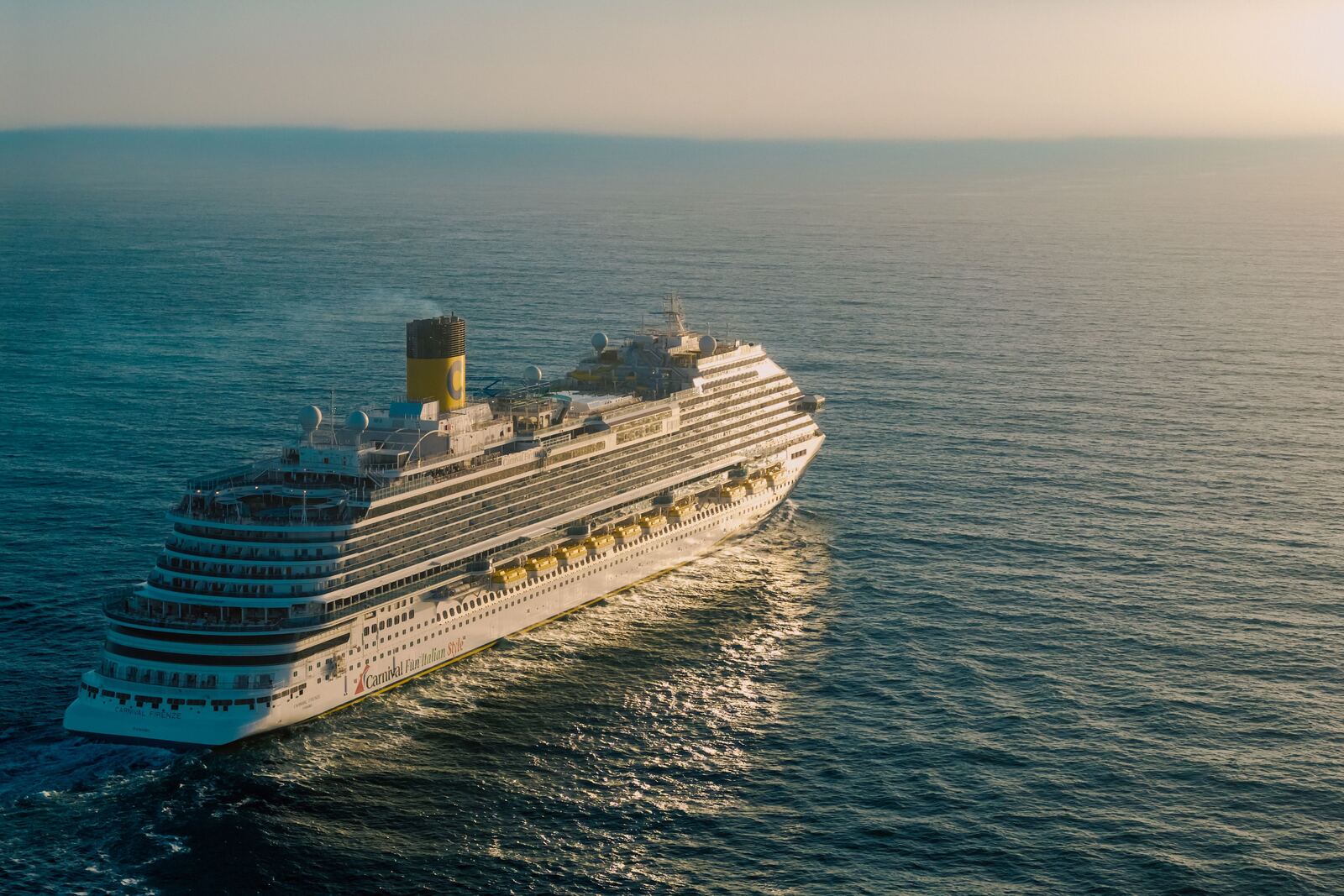 Large cruise ship sailing the open ocean at sunset