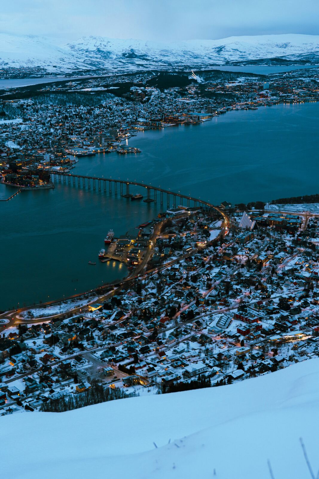 Aerial view of Tromso, Norway, surrounded by snow-capped mountains and fjords